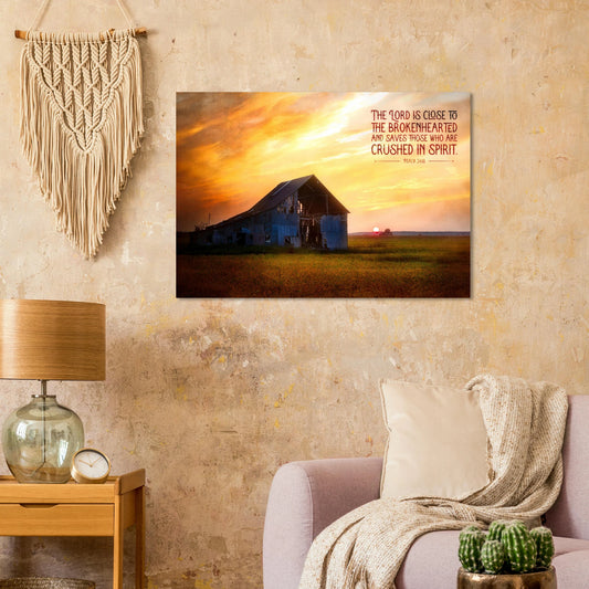 Living room with a sunset over a barn painting on the wall, lamp, and plants.