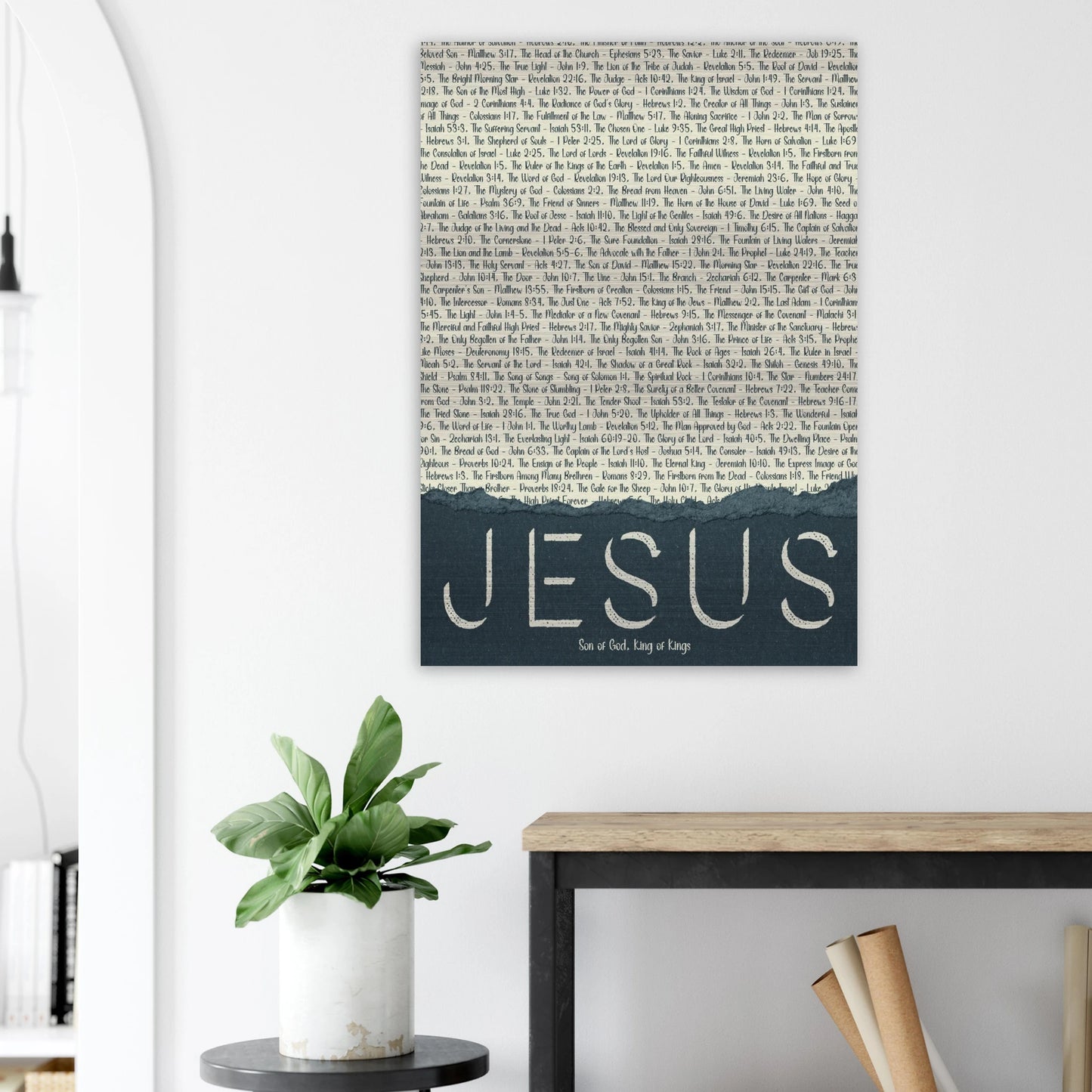jesus brushed aluminum christian metal print with scripture titles displayed above a plant on a white wall