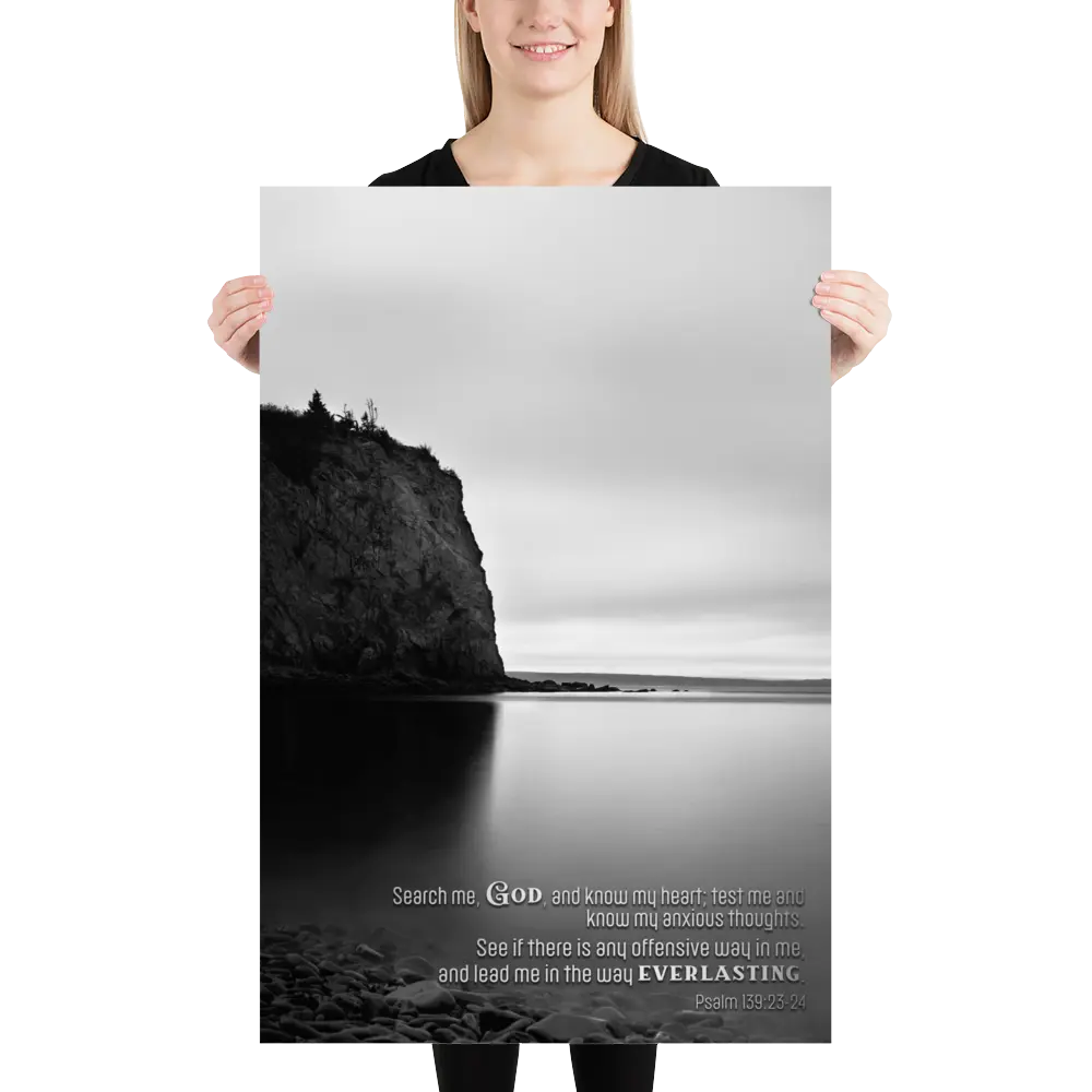 Person holding a large poster with a black and white landscape design.