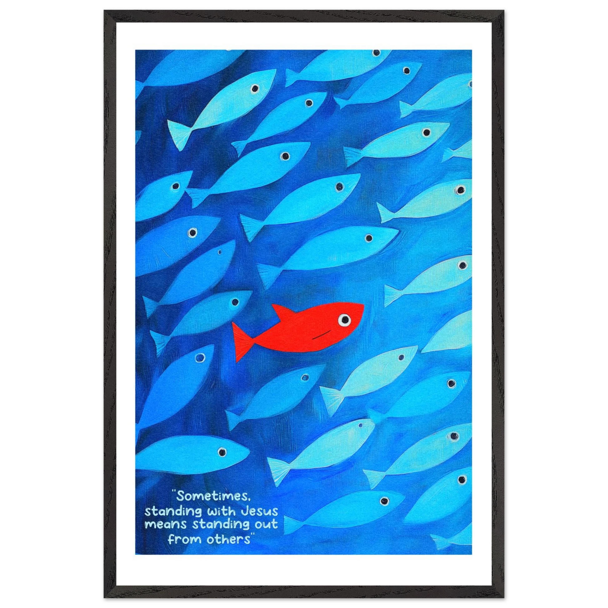 Framed wall art featuring a school of blue fish with a single red fish, and text that reads: 'Sometimes standing with Jesus means standing out from others.'.