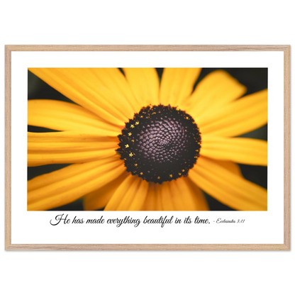 A framed art print of a close-up yellow flower with a quote from Ecclesiastes 3:11, 'He has made everything beautiful in its time.'.