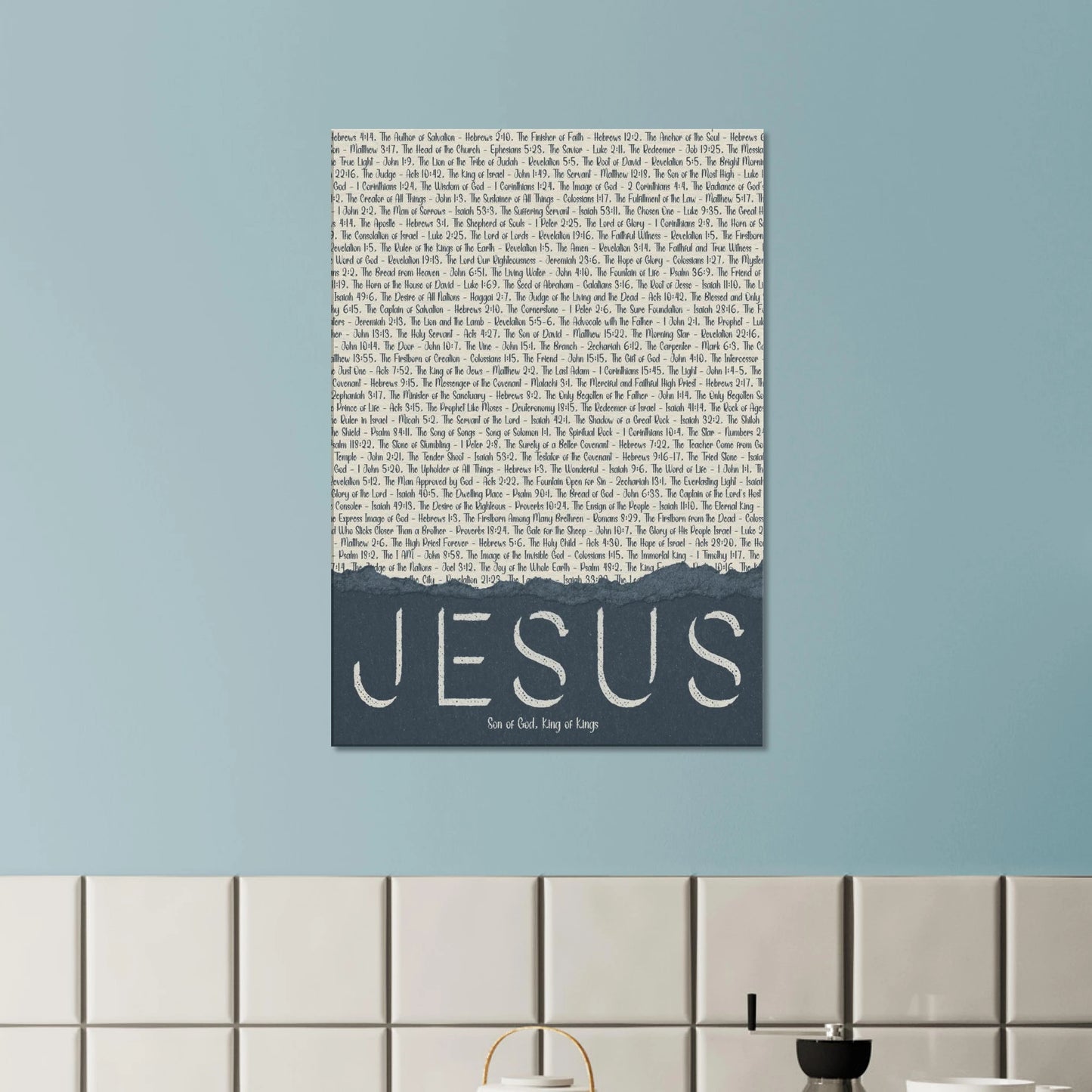 Canvas wall art with 'Jesus' text on a light blue wall.
