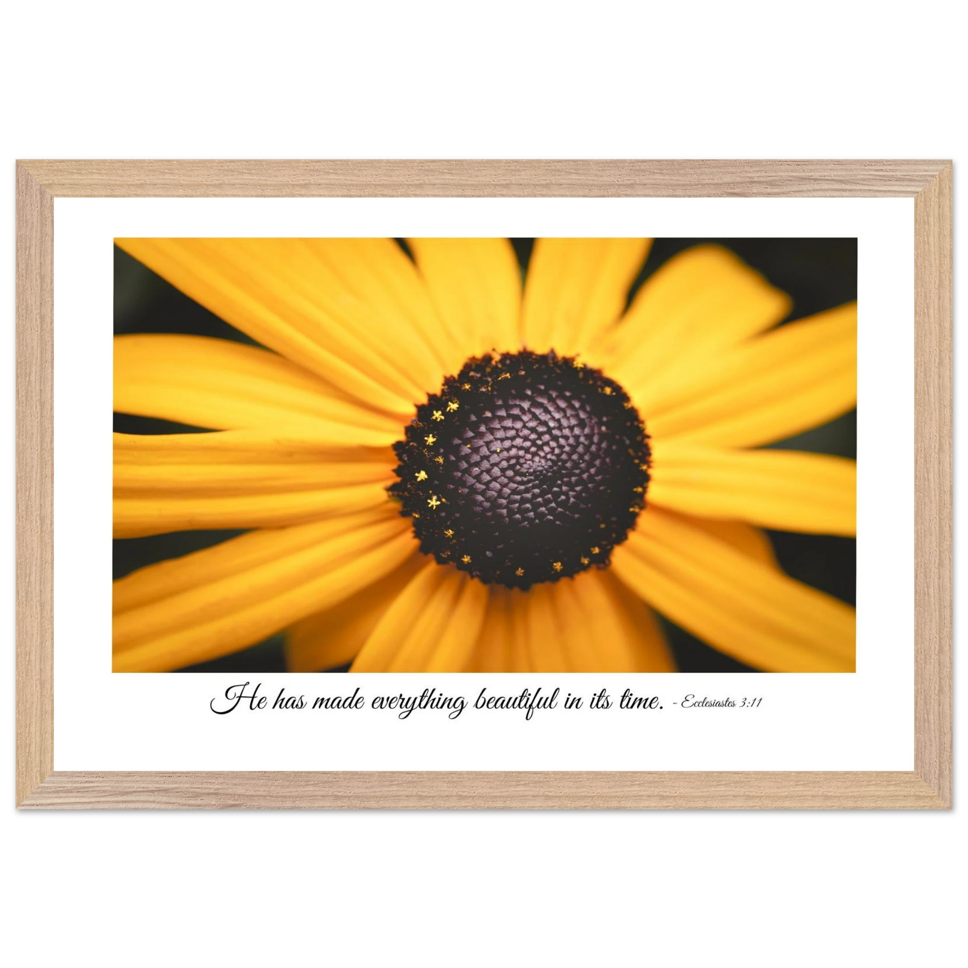 A framed art print of a close-up yellow flower with a quote from Ecclesiastes 3:11, 'He has made everything beautiful in its time.'.