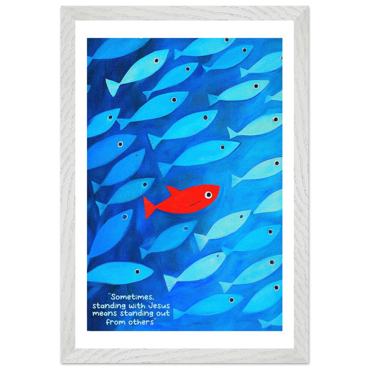 Framed wall art featuring a school of blue fish with a single red fish, and text that reads: 'Sometimes standing with Jesus means standing out from others.'.
