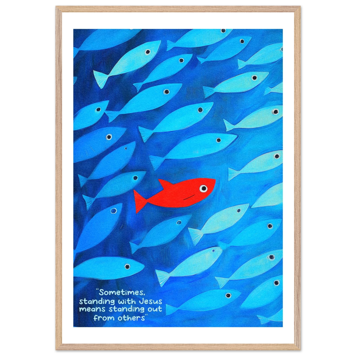 Framed wall art featuring a school of blue fish with a single red fish, and text that reads: 'Sometimes standing with Jesus means standing out from others.'.