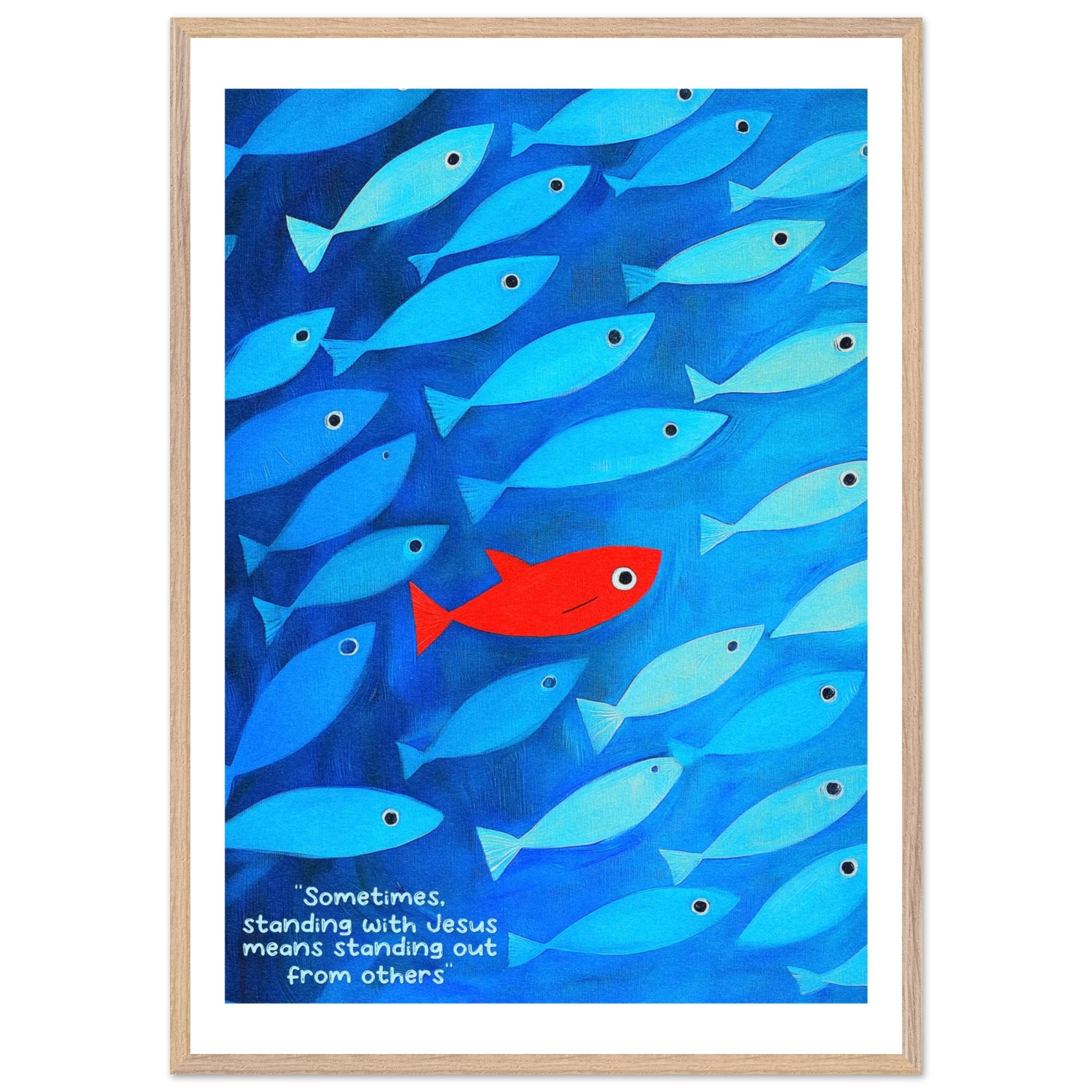 Framed wall art featuring a school of blue fish with a single red fish, and text that reads: 'Sometimes standing with Jesus means standing out from others.'.