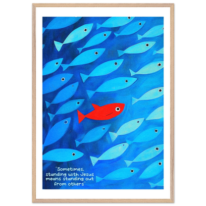 Framed wall art featuring a school of blue fish with a single red fish, and text that reads: 'Sometimes standing with Jesus means standing out from others.'.