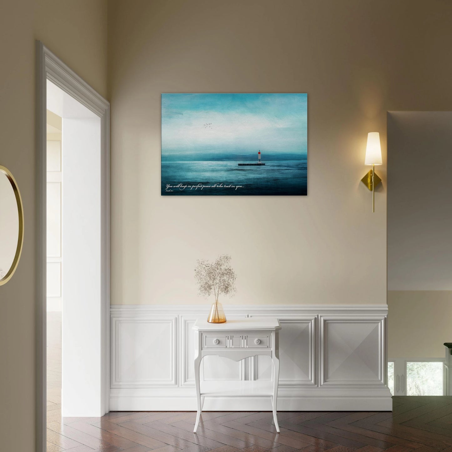 A wall art print featuring a lighthouse with a backdrop of the sea and sky, including a quote about perfect peace displayed in a cozy minimalist hall  with plant decor