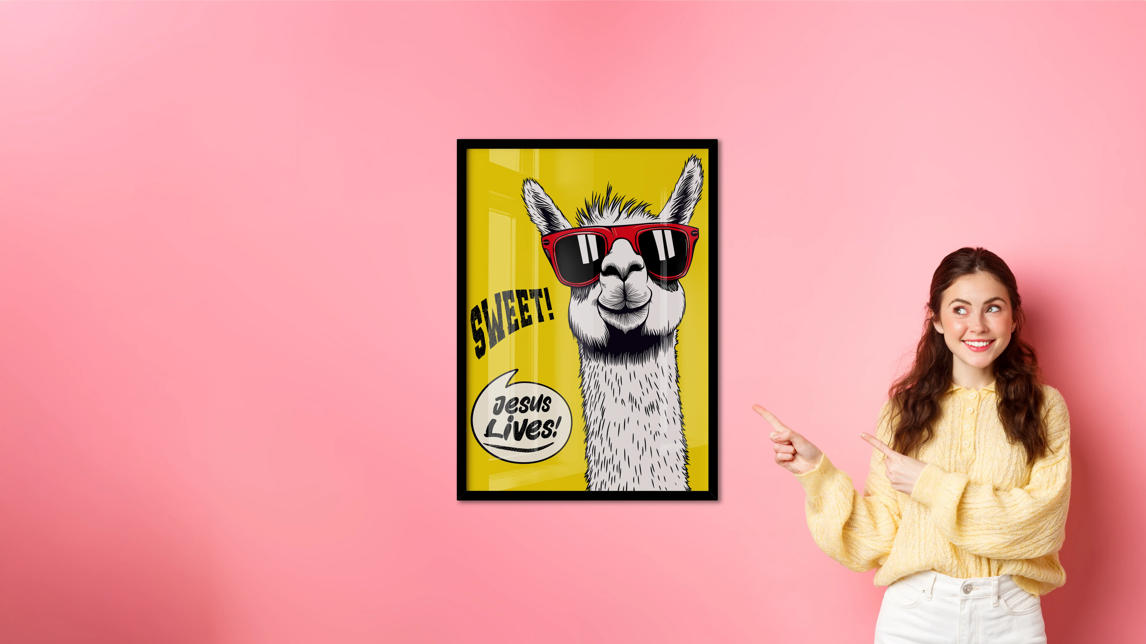 Woman pointing at a framed poster of a llama with sunglasses on a pink background