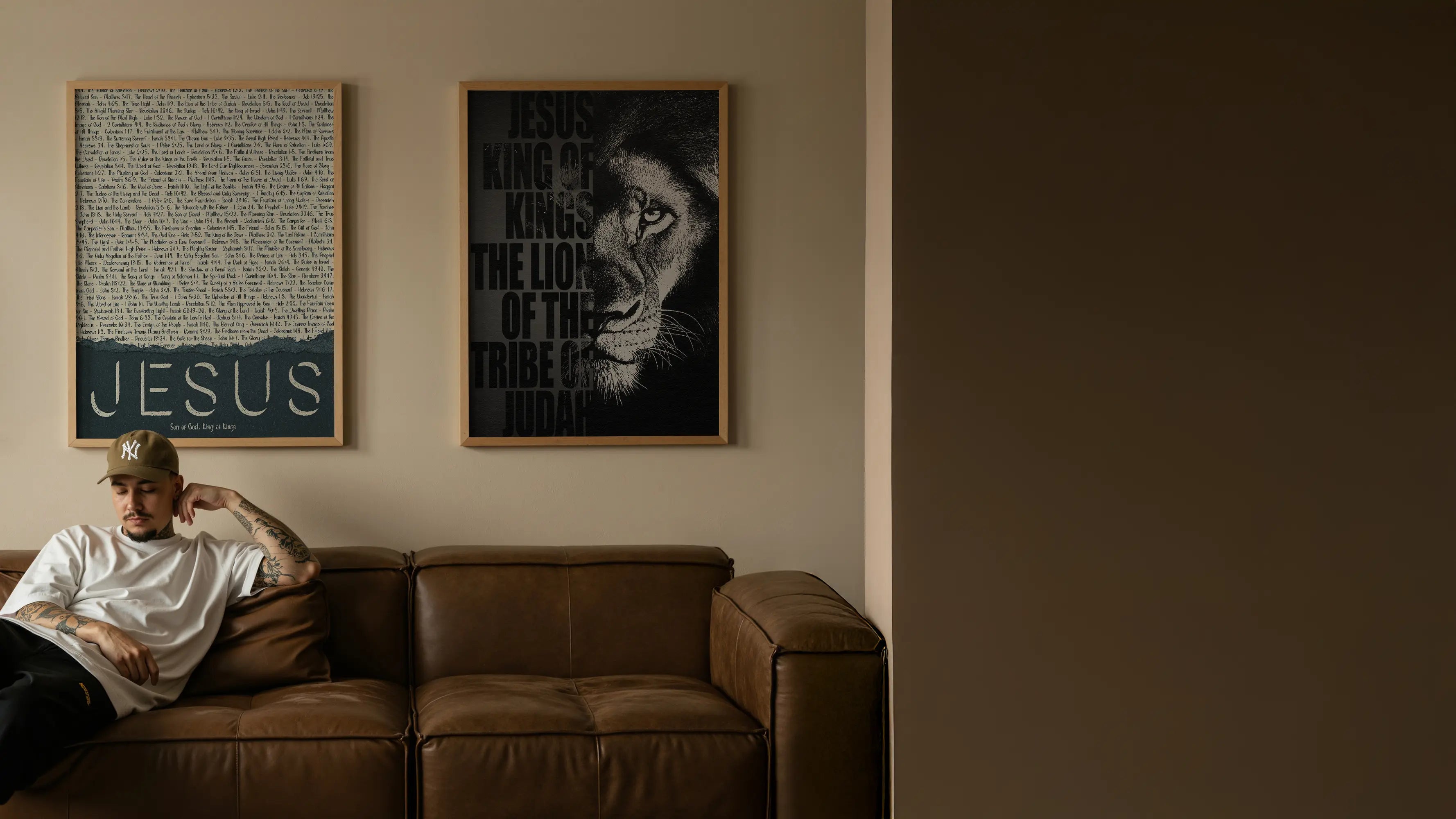 Person sitting on a brown couch with framed artwork on the wall.