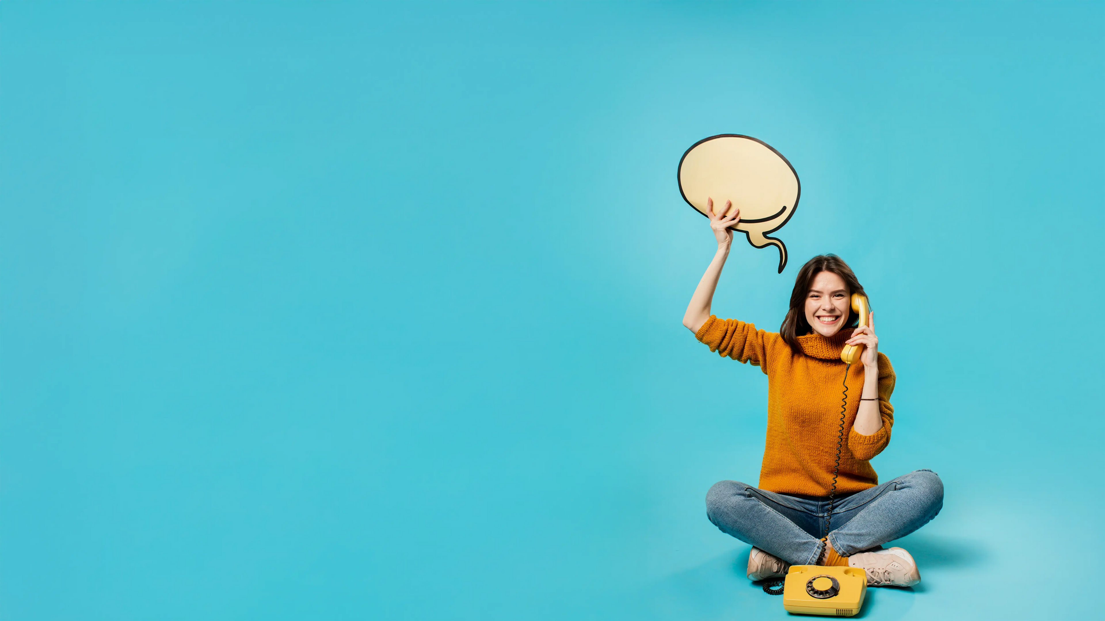 Woman holding a speech bubble against a blue background