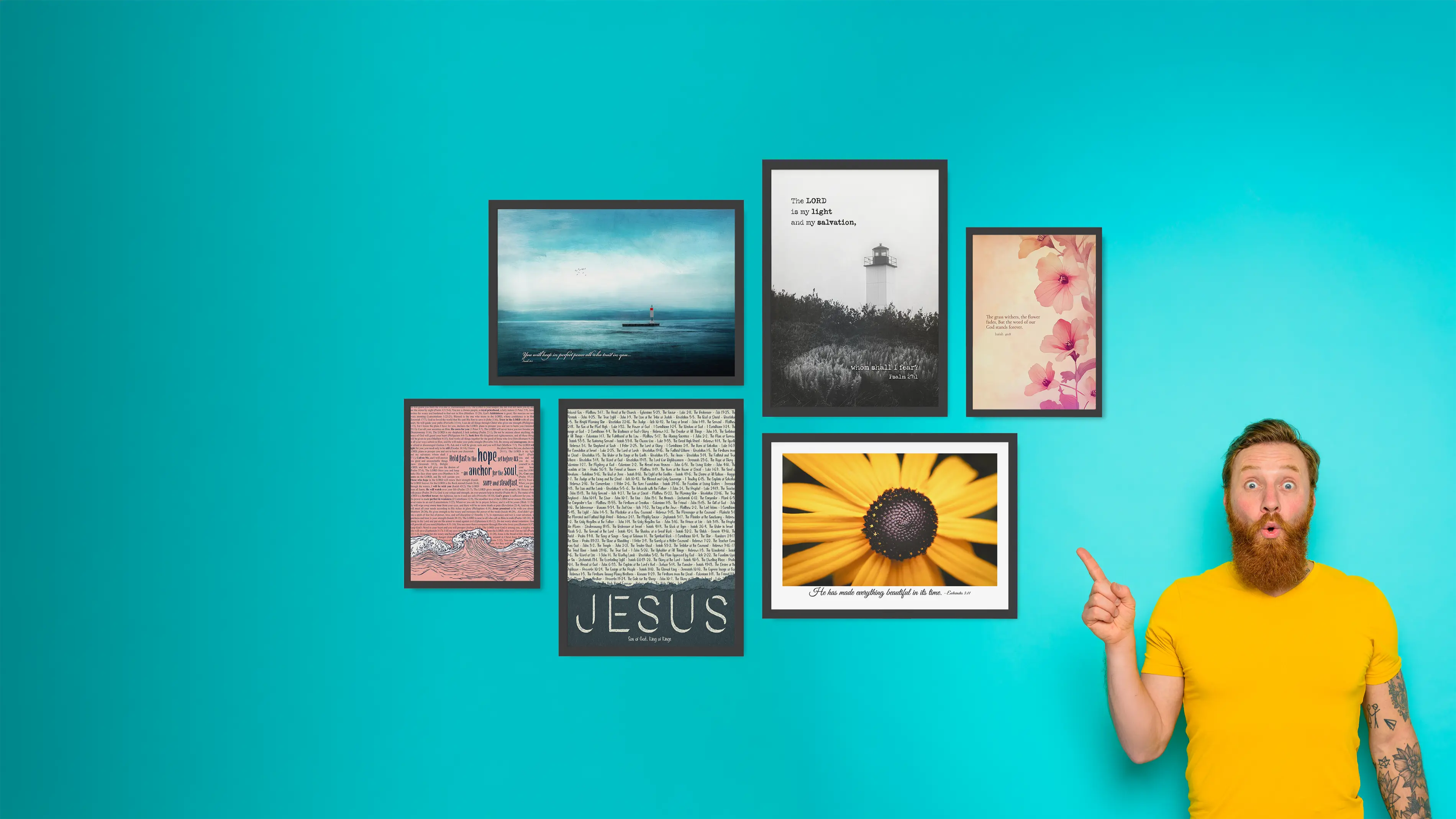 Man pointing at framed pictures on a blue wall