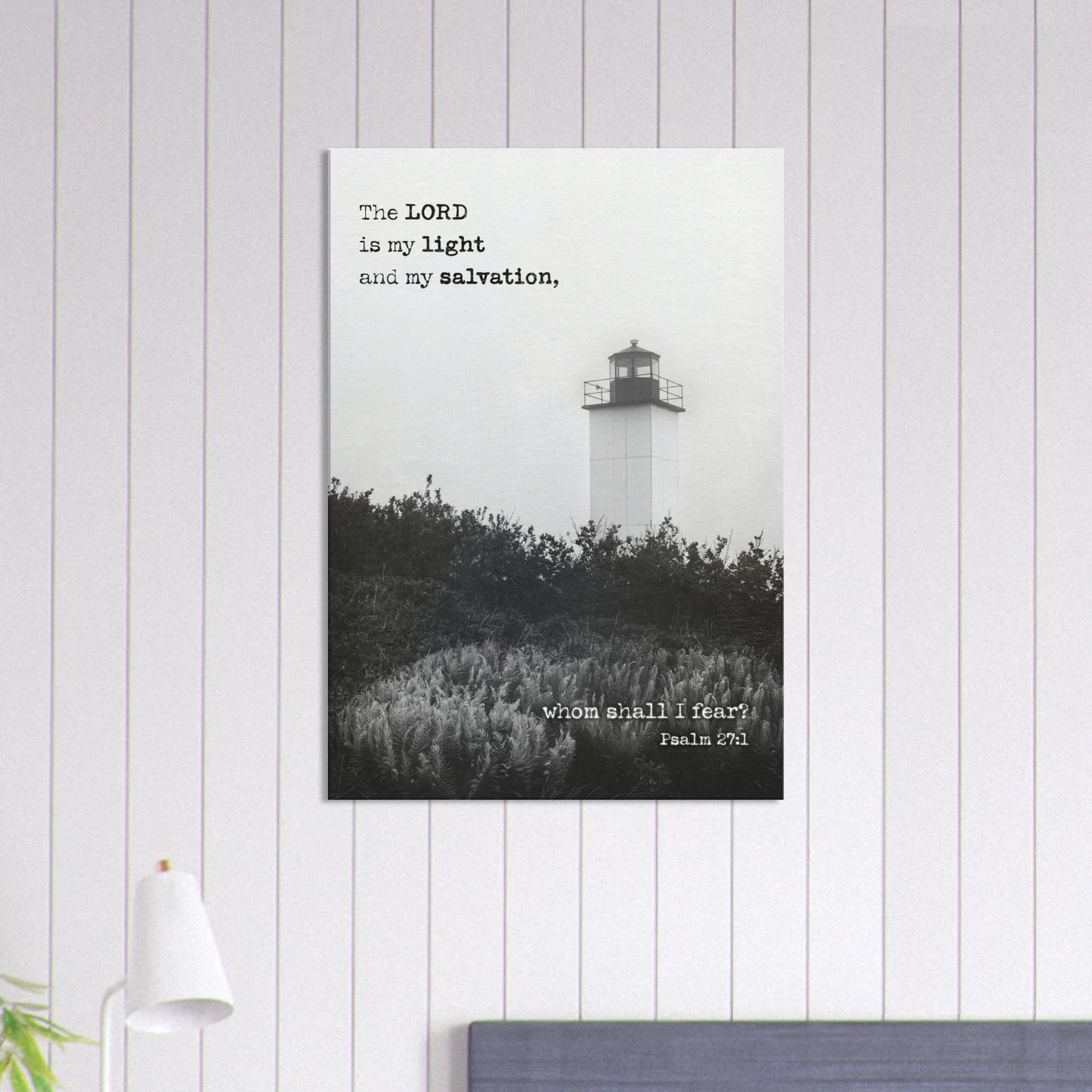 Psalm 27:1 lighthouse Christian wall art displayed in a bedroom on a light gray vertical-paneled wall.