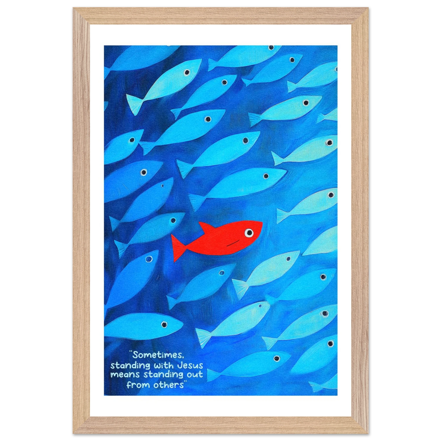 Framed wall art featuring a school of blue fish with a single red fish, and text that reads: 'Sometimes standing with Jesus means standing out from others.'.