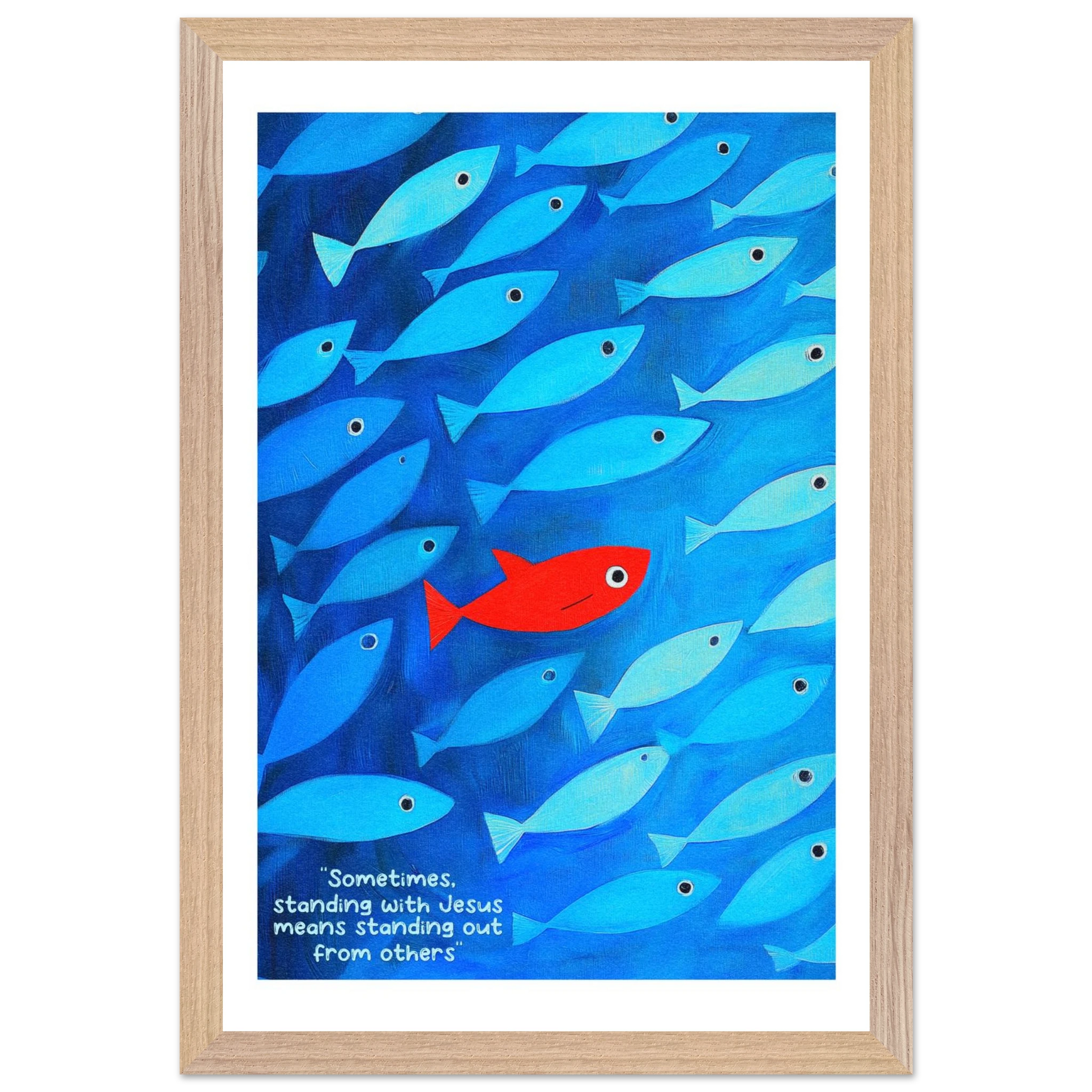 Framed wall art featuring a school of blue fish with a single red fish, and text that reads: 'Sometimes standing with Jesus means standing out from others.'.