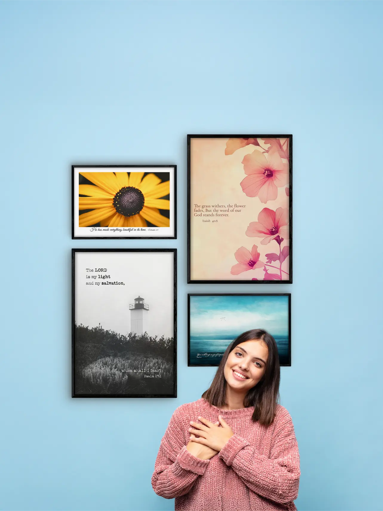 Woman standing in front of a wall with four framed pictures on a light blue background