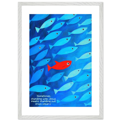 Framed wall art featuring a school of blue fish with a single red fish, and text that reads: 'Sometimes standing with Jesus means standing out from others.'.