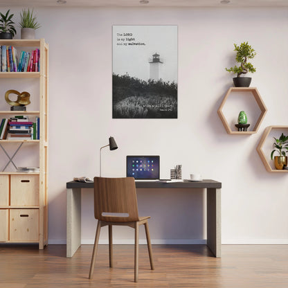 A framed Christian wall art print featuring a lighthouse and Bible verse hangs above a minimalist desk setup in a modern home office.