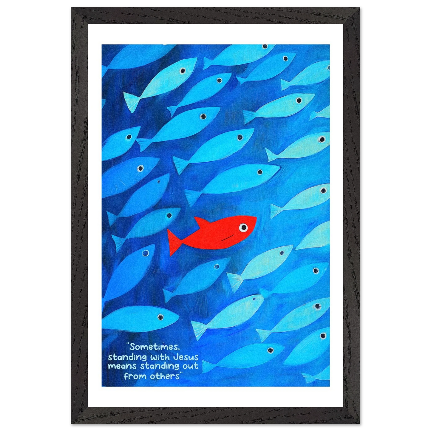 Framed wall art featuring a school of blue fish with a single red fish, and text that reads: 'Sometimes standing with Jesus means standing out from others.'.