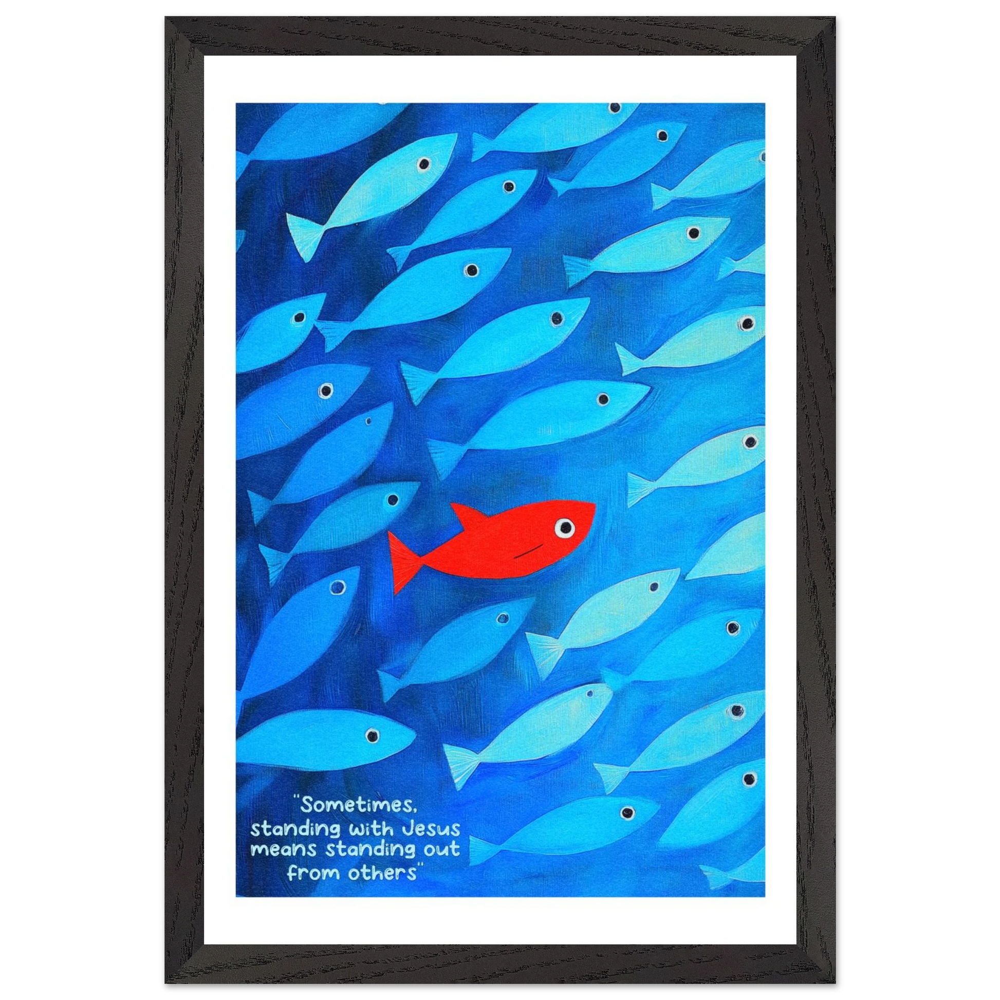 Framed wall art featuring a school of blue fish with a single red fish, and text that reads: 'Sometimes standing with Jesus means standing out from others.'.