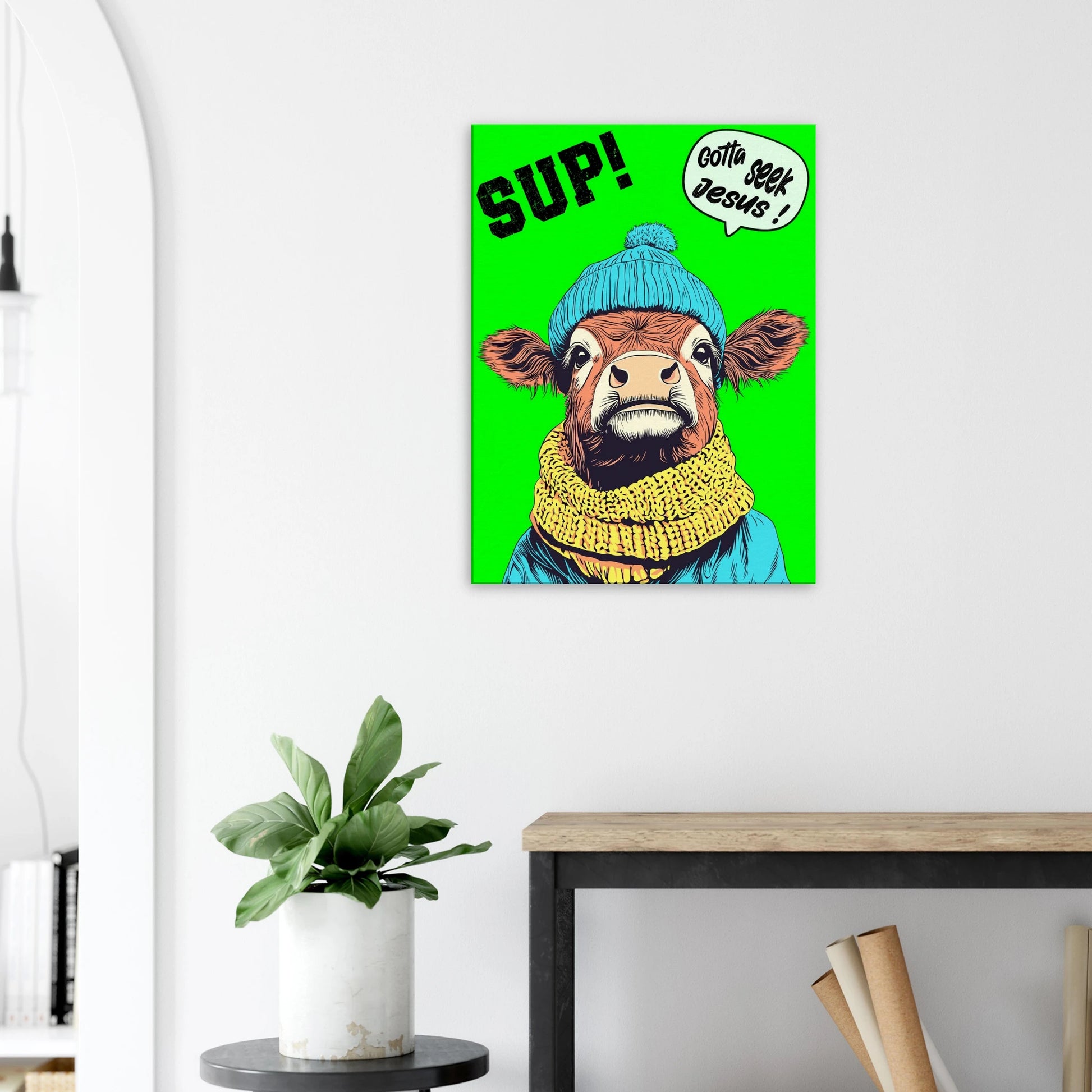 A vibrant green canvas featuring a cartoon style Highland cow with a beanie hat and a scarf, holding a sign with the text 'Gotta Seek Jesus' displayed in a bright minimalist room with small plant decor