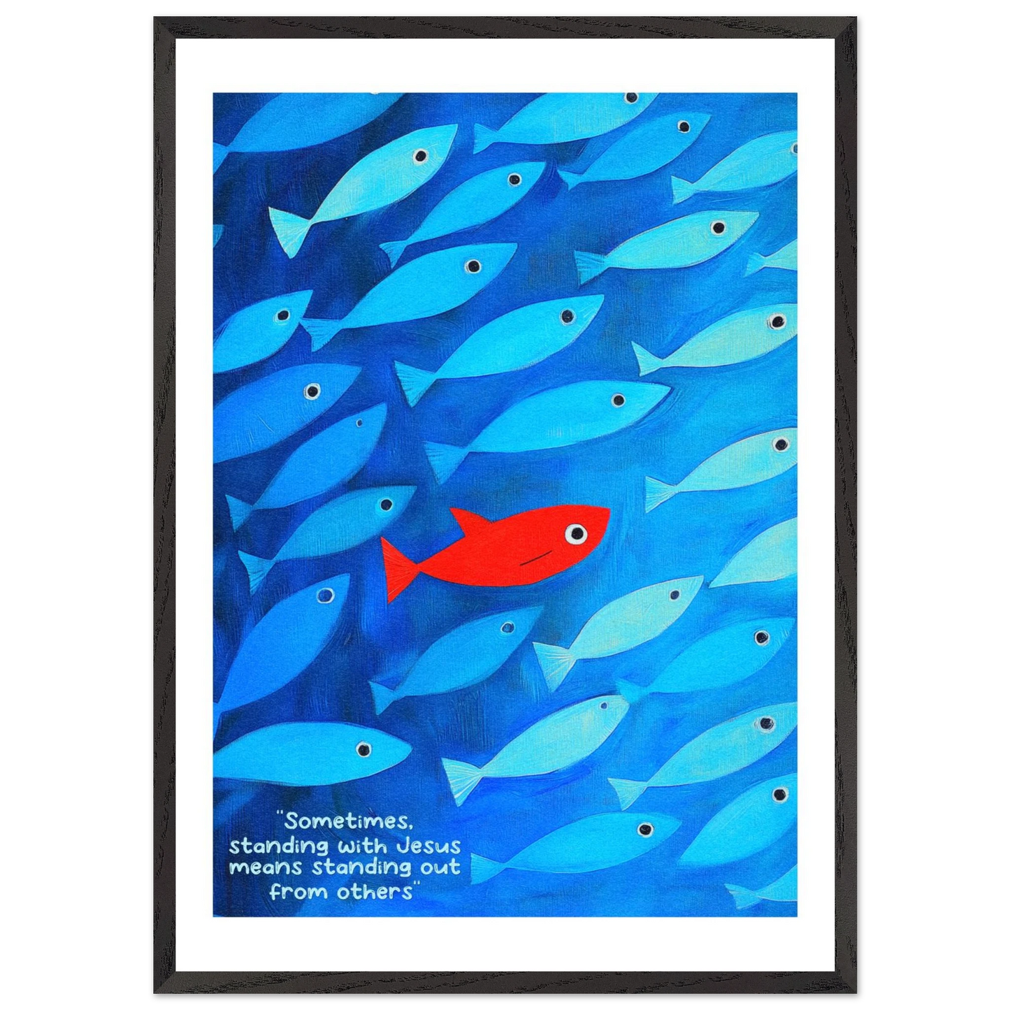 Framed wall art featuring a school of blue fish with a single red fish, and text that reads: 'Sometimes standing with Jesus means standing out from others.'.