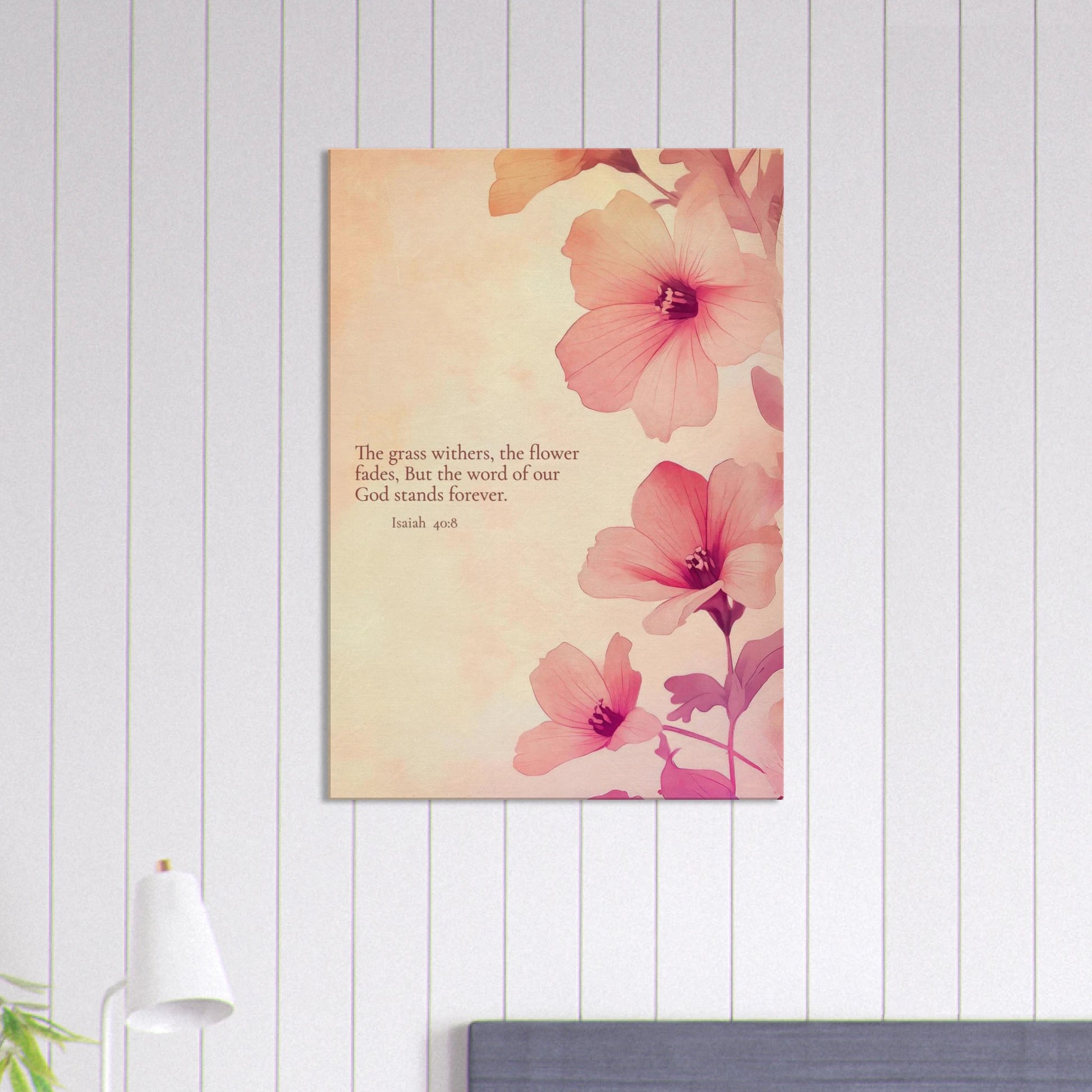 wall art print featuring floral design with pink flowers and the text of Isaiah 40:8 scripture, titled 'The Word of God Stands Forever' hanging over a modern minimalist room with lamp decor