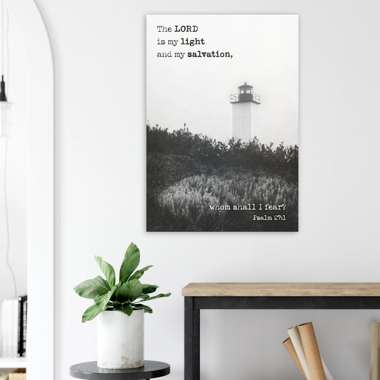 Wall art with a lighthouse and Bible verse on a white wall above a desk.