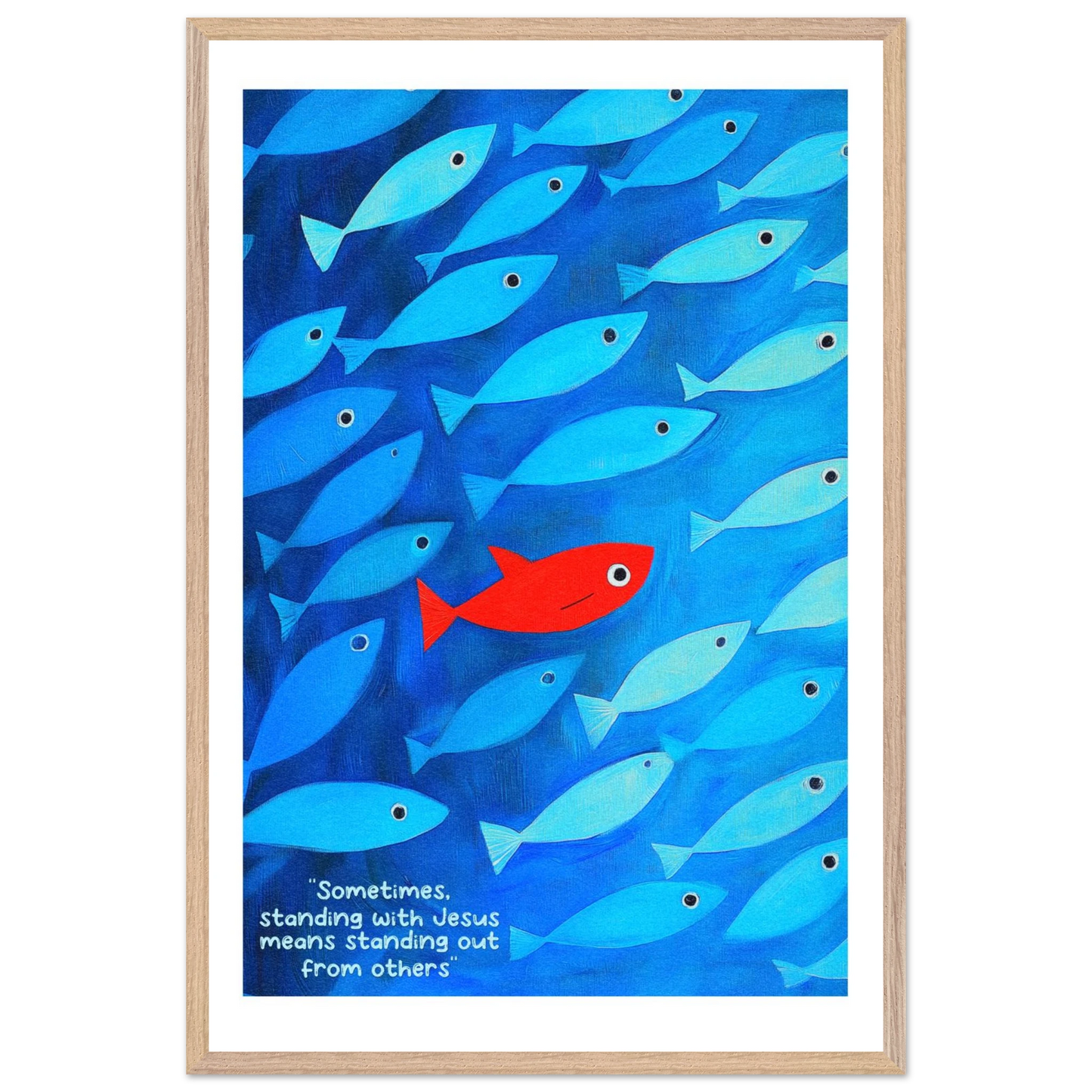 Framed wall art featuring a school of blue fish with a single red fish, and text that reads: 'Sometimes standing with Jesus means standing out from others.'.