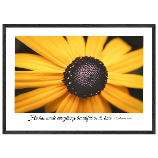 A framed art print of a close-up yellow flower with a quote from Ecclesiastes 3:11, 'He has made everything beautiful in its time.'.
