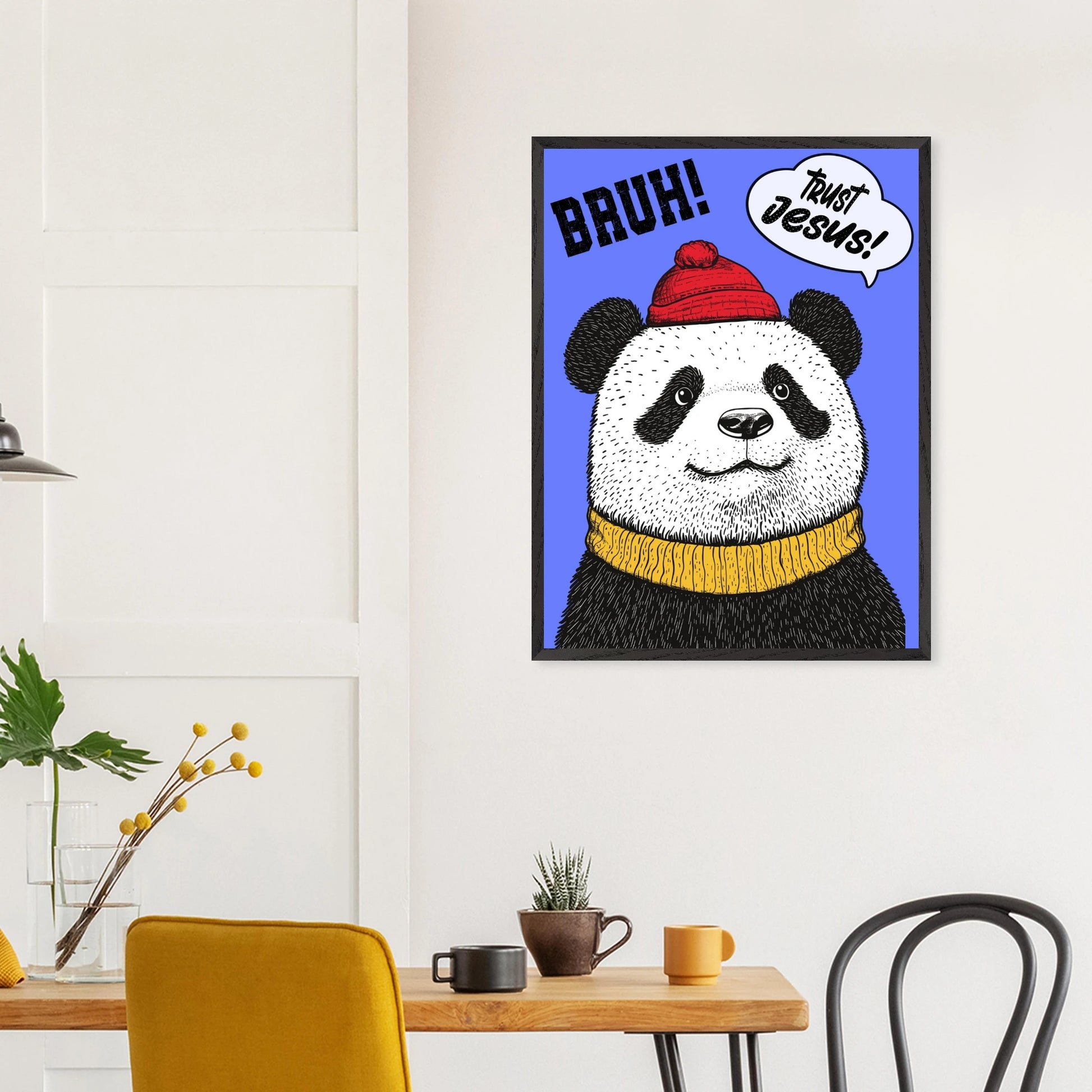 Playful Christian wall art illustration of a panda wearing a red beanie and yellow sweater on a blue background with the words BRUH and Trust Jesus in speech bubbles hanging above a wooden table in a modern dining space