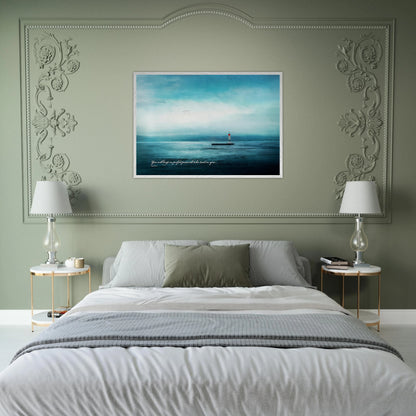 serene blue seascape lighthouse artwork displayed above cozy neutral bed