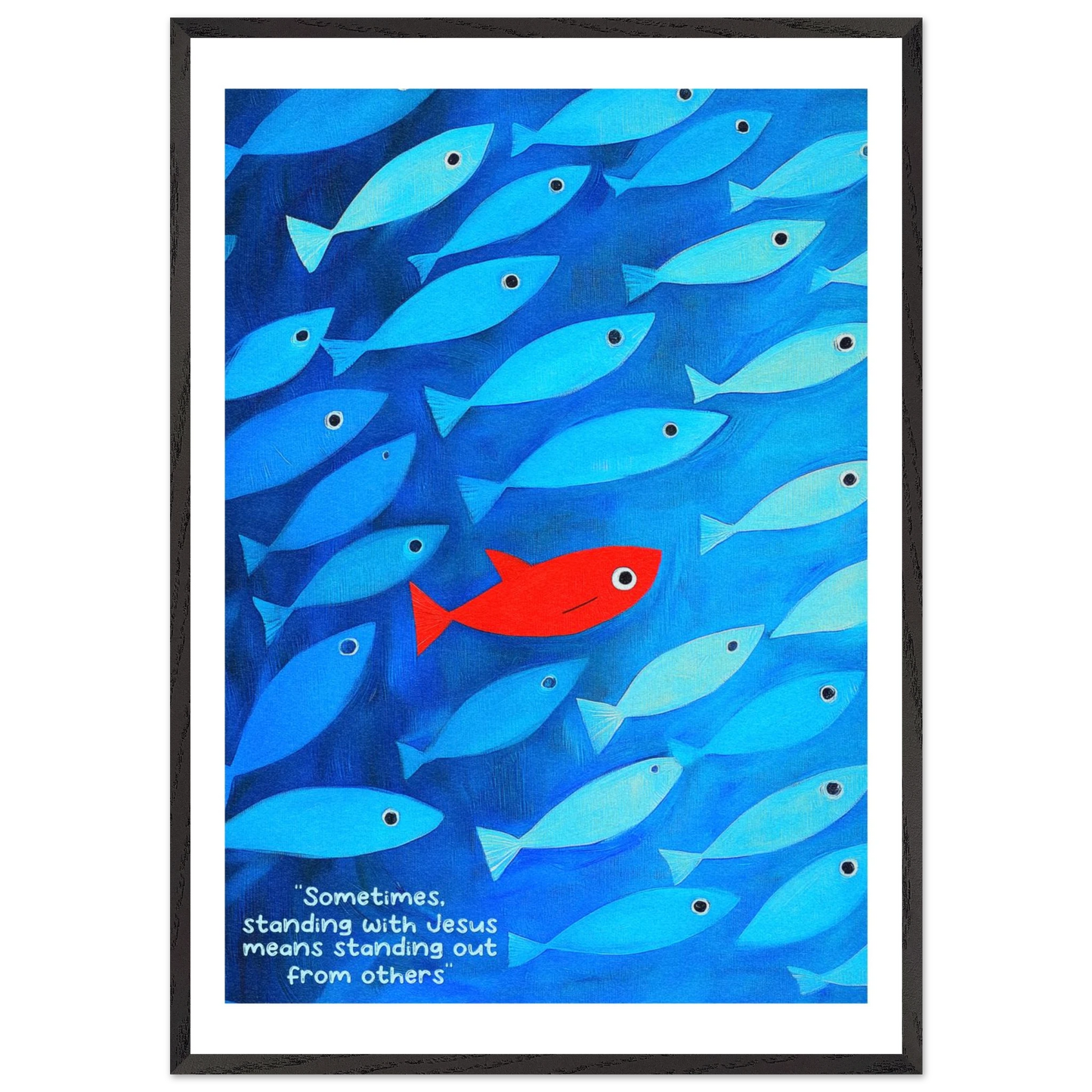 Framed wall art featuring a school of blue fish with a single red fish, and text that reads: 'Sometimes standing with Jesus means standing out from others.'.