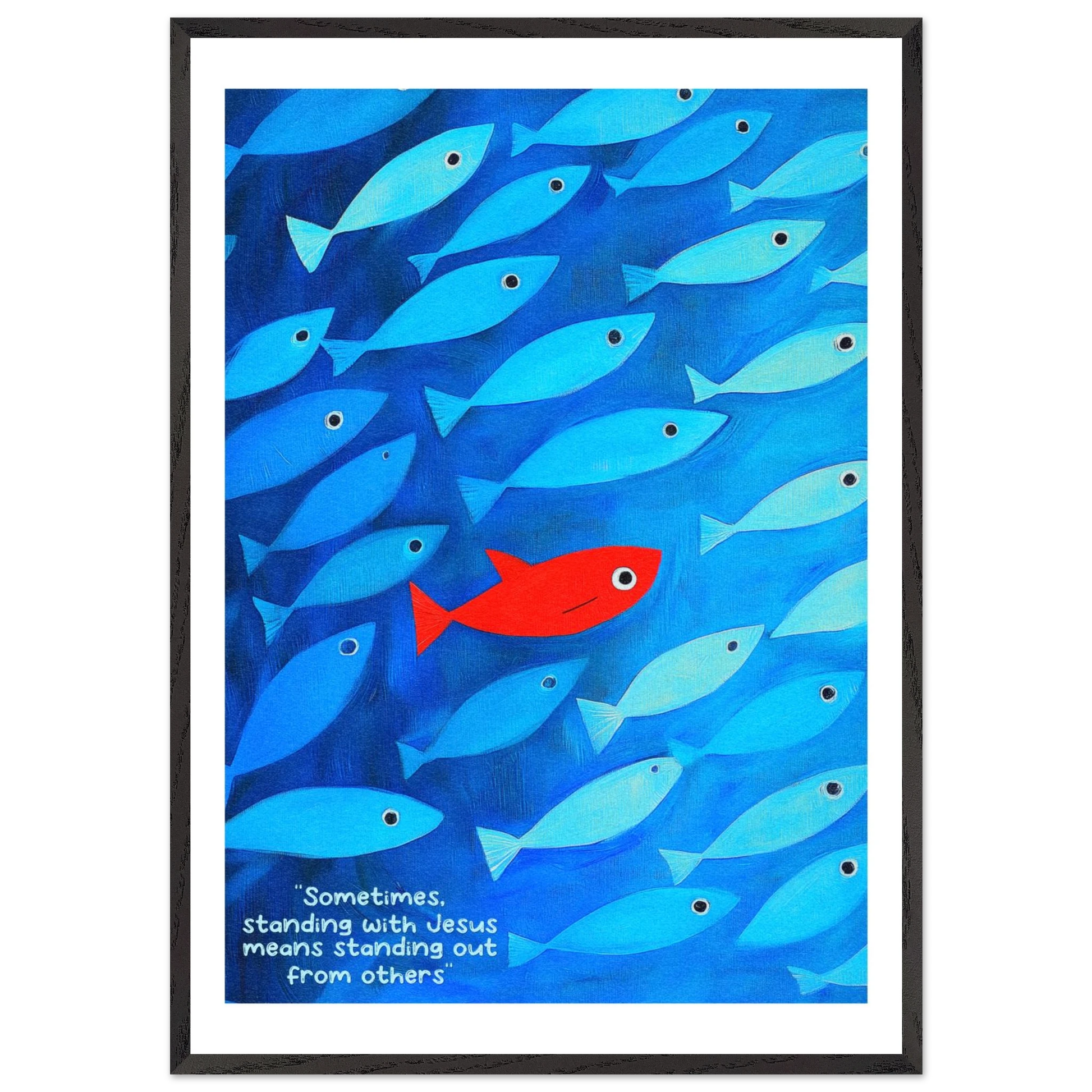 Framed wall art featuring a school of blue fish with a single red fish, and text that reads: 'Sometimes standing with Jesus means standing out from others.'.