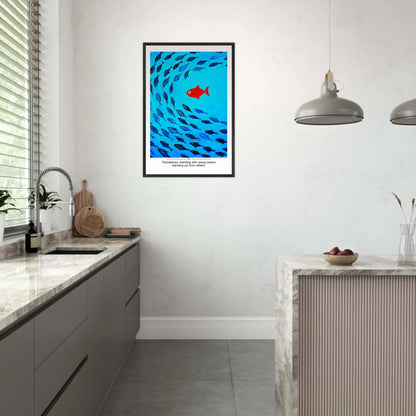 Framed Christian wall art featuring a red fish swimming in water with blue fish, and the text 'Sometimes standing with Jesus means standing out from others' as a quote displayed in a modern minimalist kitchen area