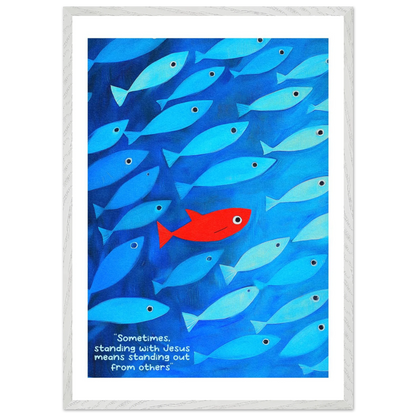 Framed wall art featuring a school of blue fish with a single red fish, and text that reads: 'Sometimes standing with Jesus means standing out from others.'.