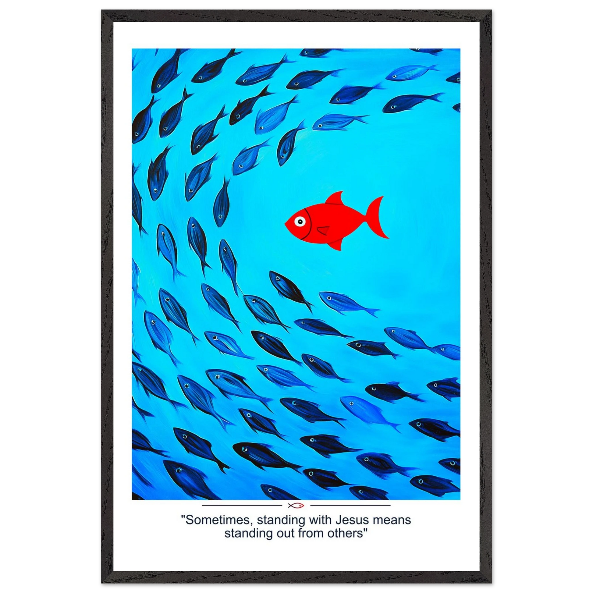 Framed Christian wall art featuring a red fish swimming in water with blue fish, and the text 'Sometimes standing with Jesus means standing out from others' as a quote.