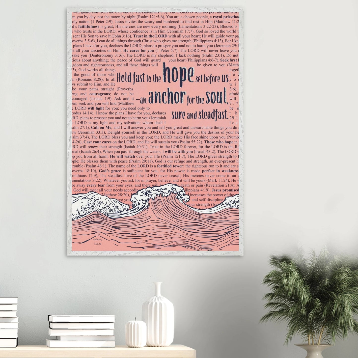 framed christian wall art in pink featuring wave and anchor design with bible verses hanging above a modern white shelf