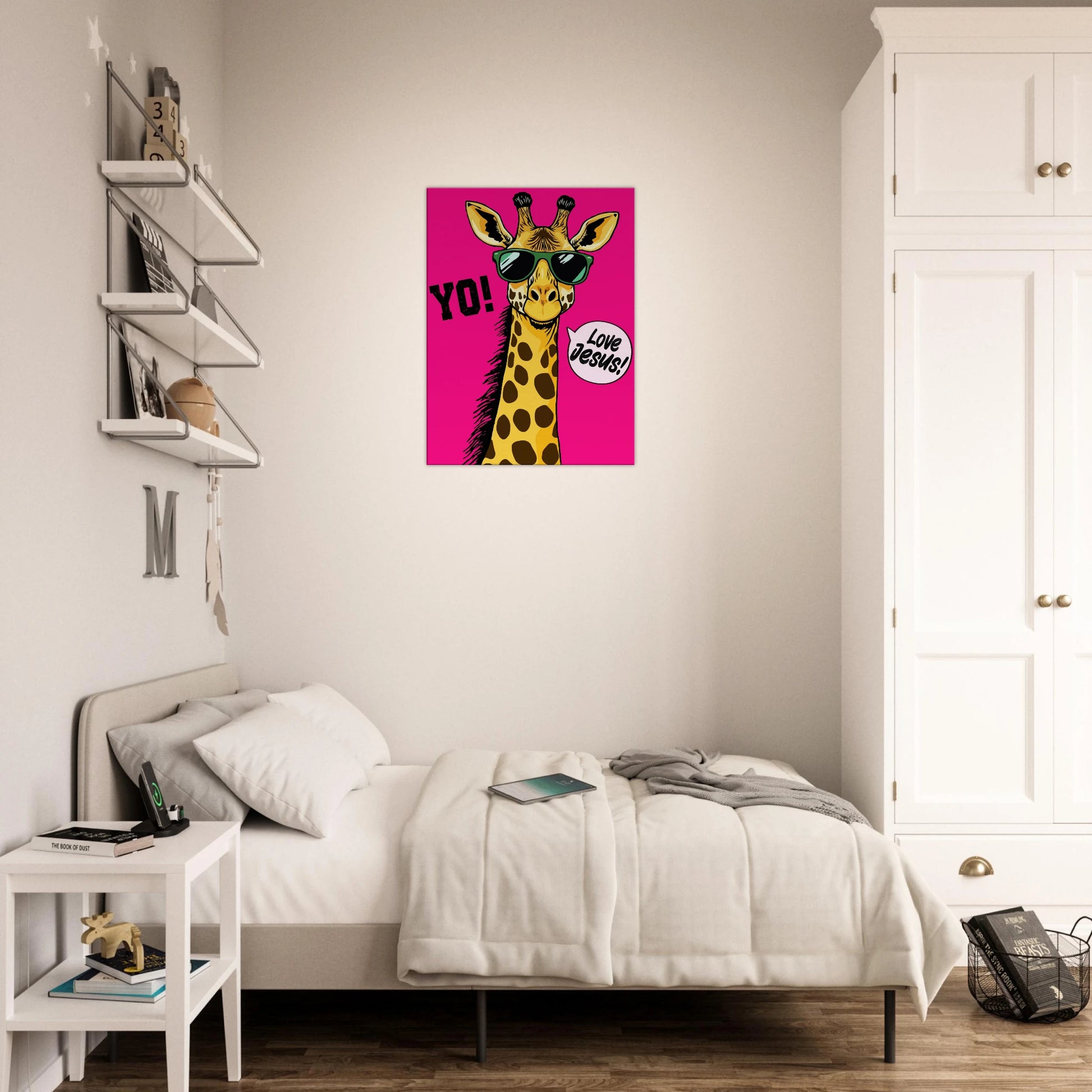 A vibrant pink poster featuring a cartoon giraffe with sunglasses and a speech bubble with the phrase 'Love Jesus!' The giraffe is the central figure against a vivid pink background displayed in a bright minimalist bedroom