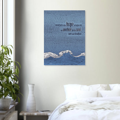 christian metal print with wave and anchor artwork and scripture text in pink and silver colors hanging above a bed in a bright minimalist bedroom