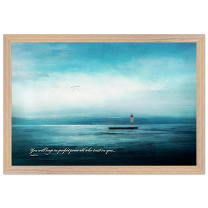 A framed poster featuring a lighthouse in a serene seascape with the text 'You will keep in perfect peace all who trust in you.' from Isaiah 26:3.