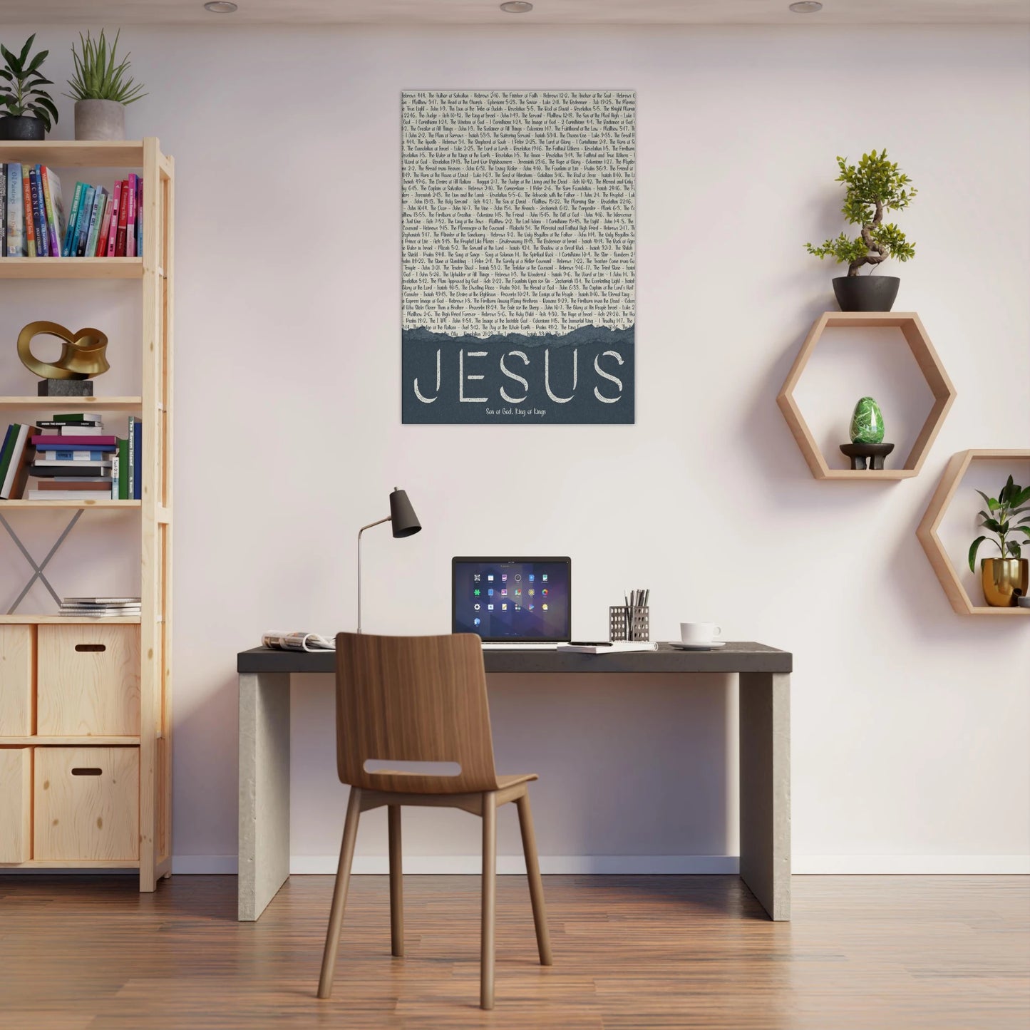 Modern home office with a desk, chair, and wall art featuring the word 'Jesus'.