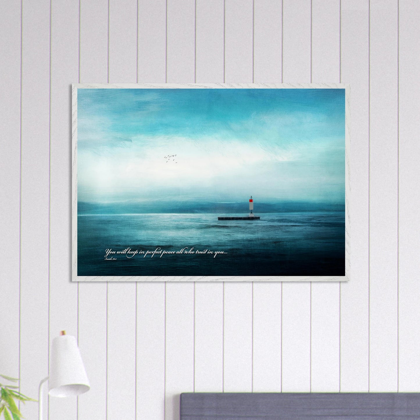 peaceful seascape lighthouse wall art on white shiplap wall in coastal style room