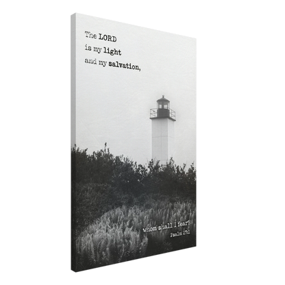 A canvas wall art print featuring a lighthouse with a black and white coastal landscape and the text of Psalm 27:1 which reads 'The Lord is my light and my salvation.'.