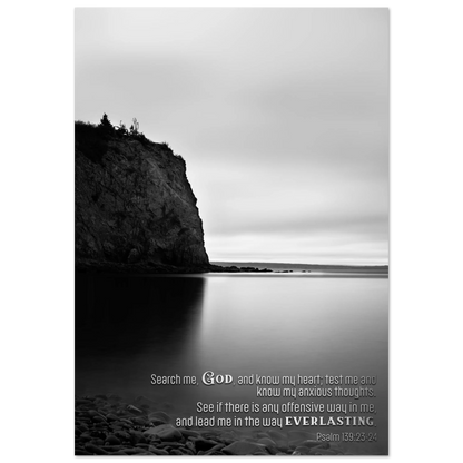Black and white landscape with a cliff and water, featuring a religious quote.