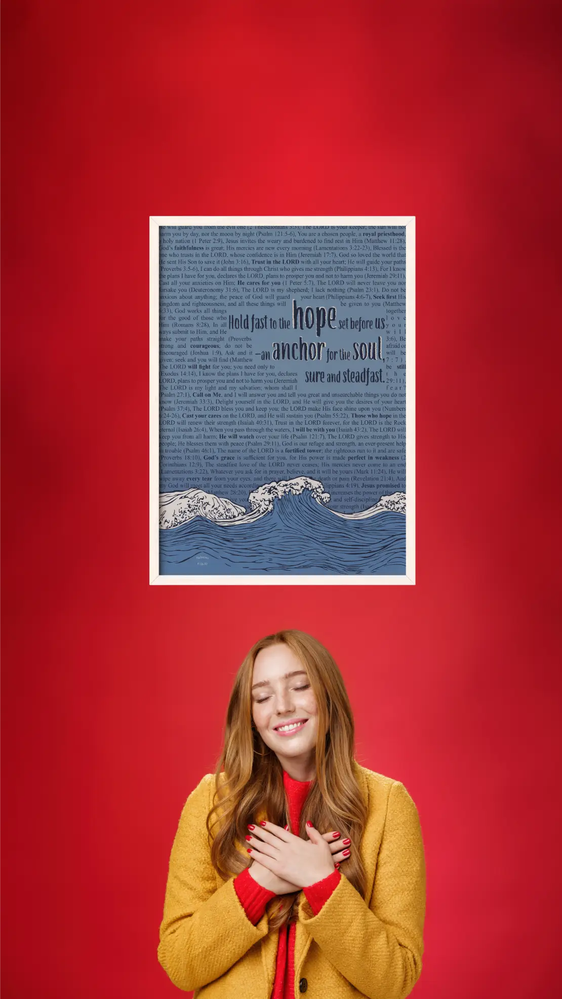 Woman in yellow coat standing next to a framed text print on a red background