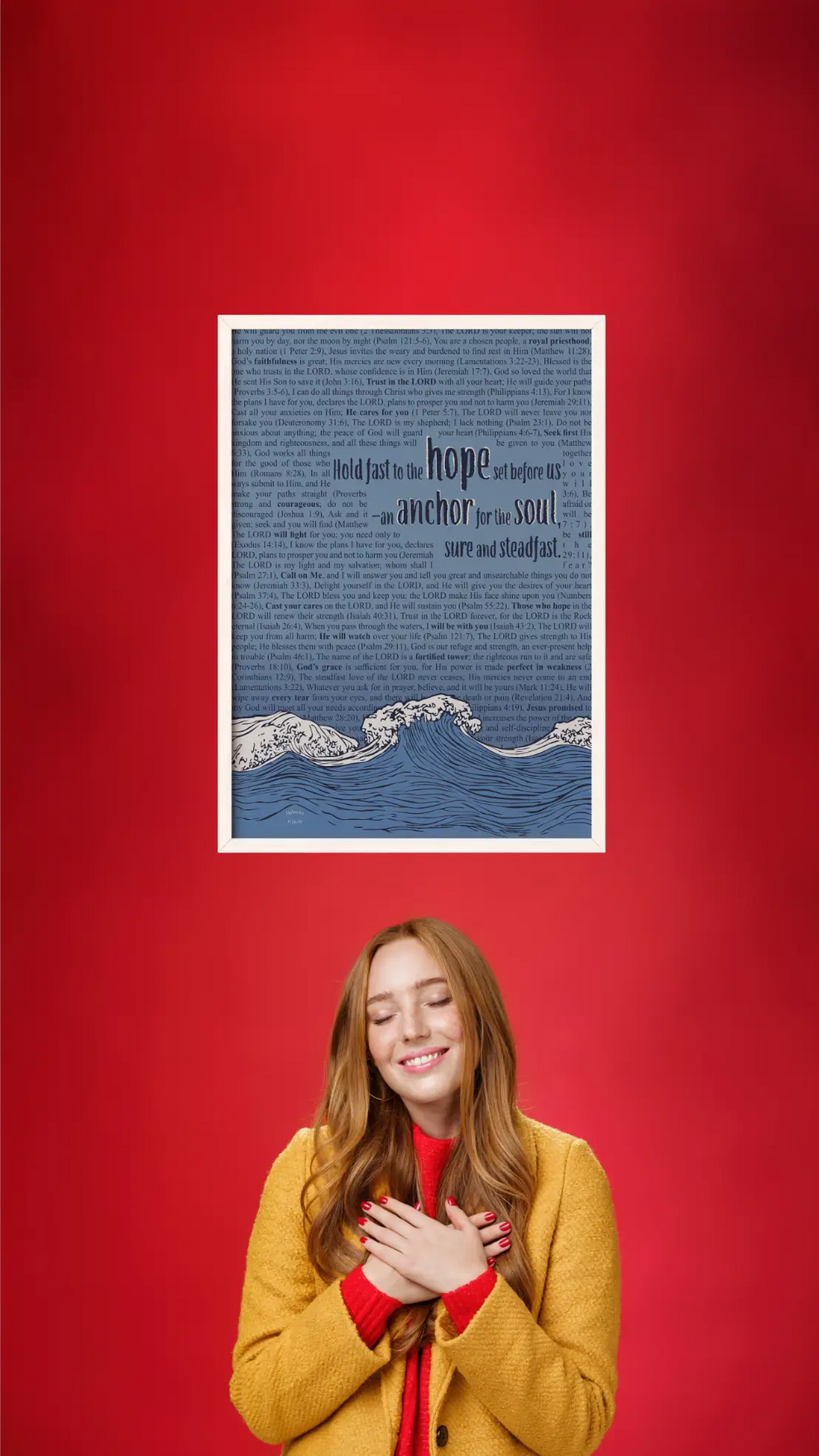 Woman in yellow coat standing next to a framed text print on a red background