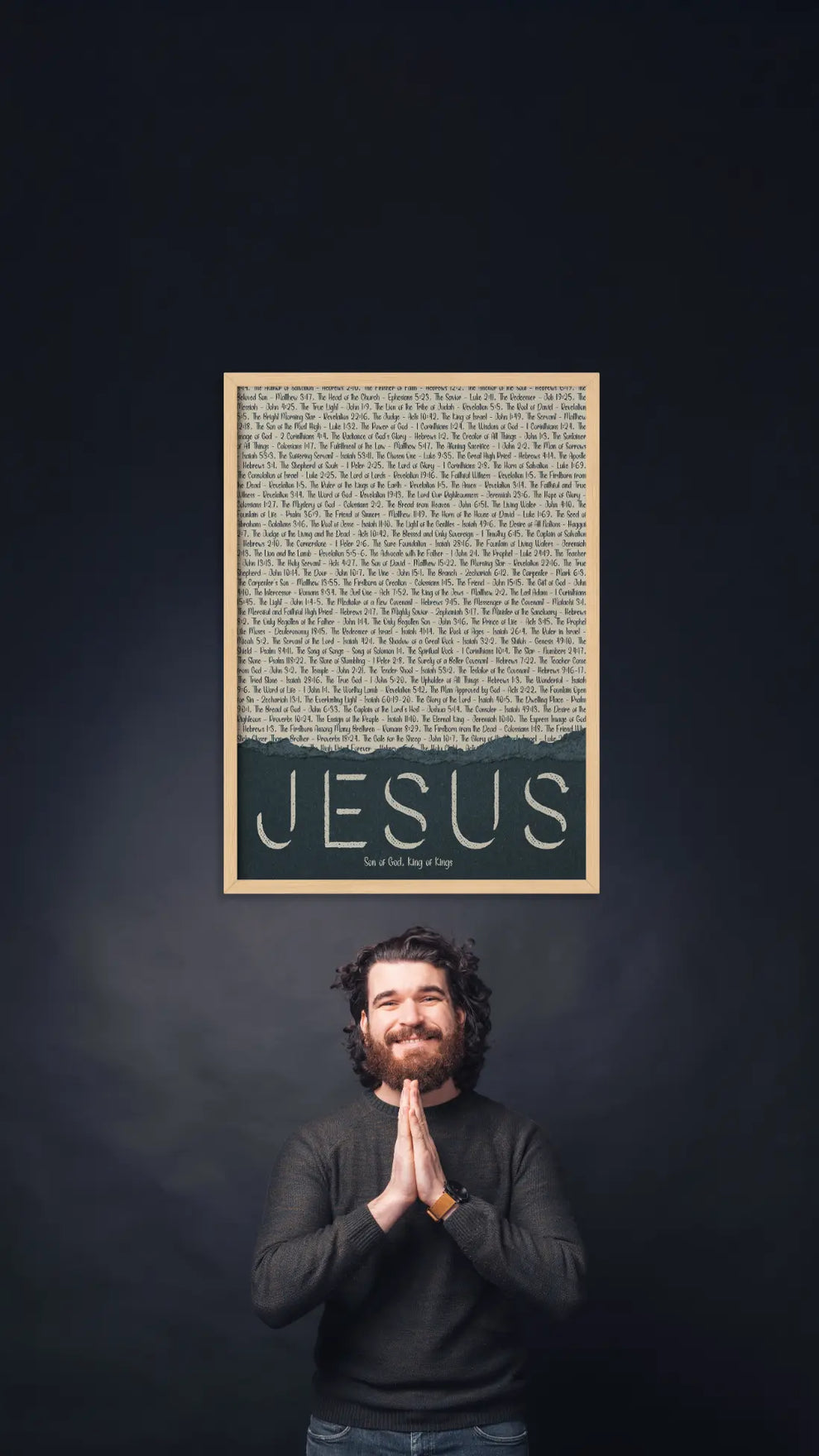 Man standing in front of a framed text poster with 'Jesus' on a dark background