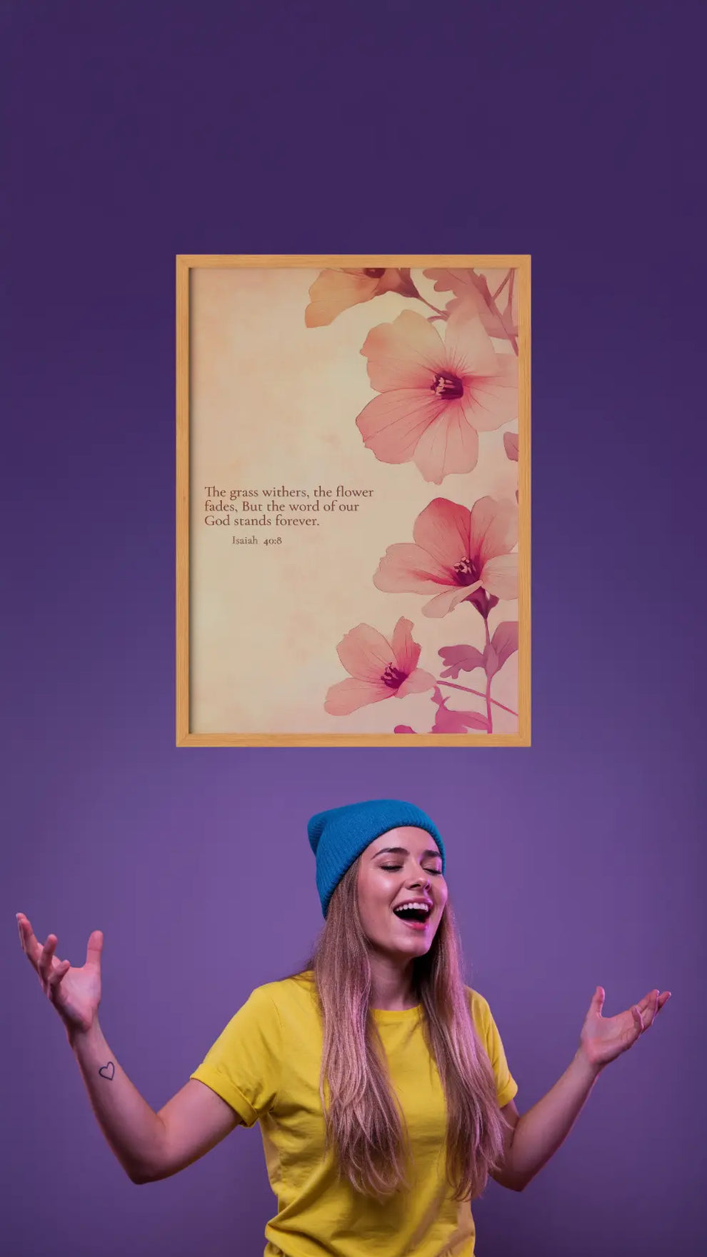 Woman in yellow shirt and blue beanie with a floral framed picture on a purple background