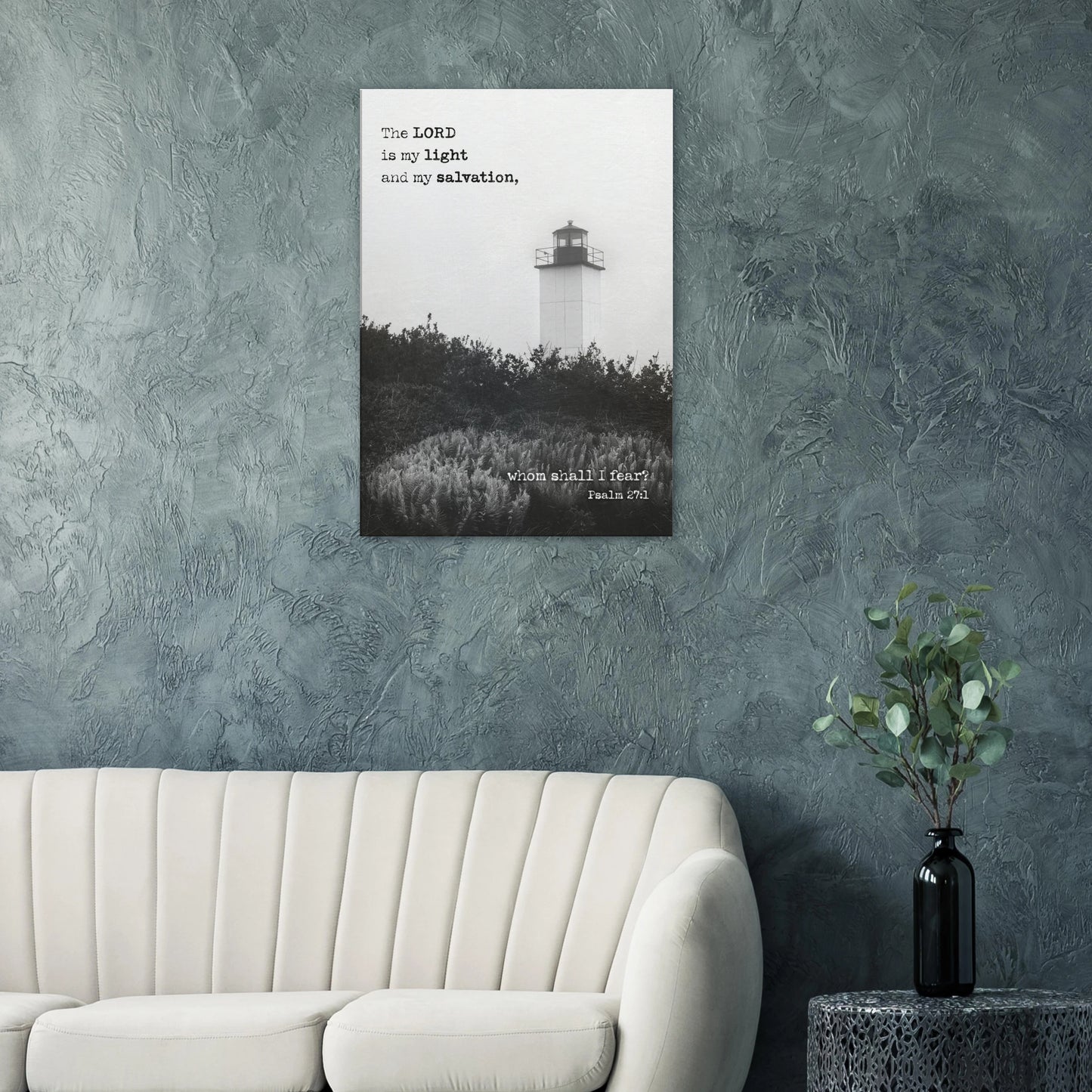 Psalm 27:1 lighthouse Christian wall art hanging on a textured blue wall above a modern cream sofa.